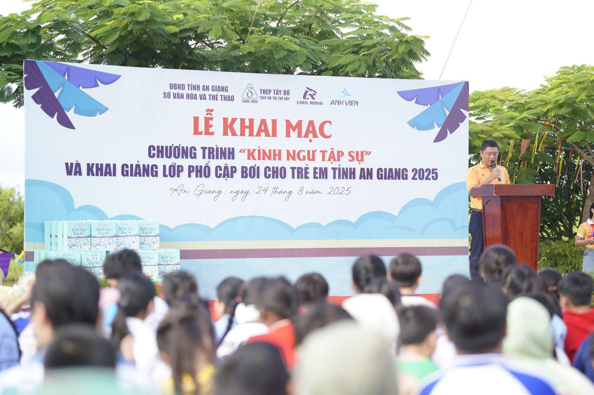 A person standing in front of a large banner  AI-generated content may be incorrect.